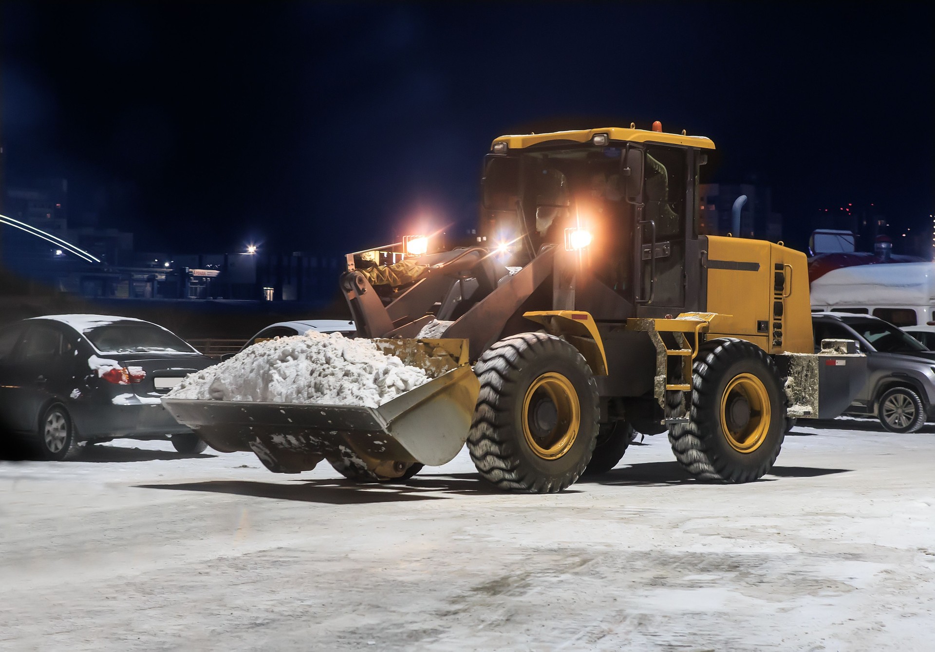 Snow removal with a loader in a parking lot